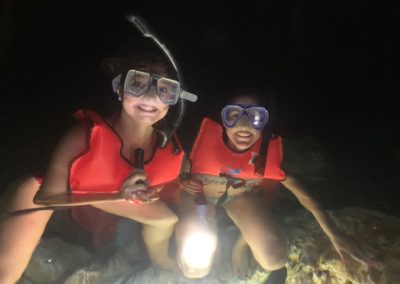 Girls snorkeling in underground lake at Chicho Cave